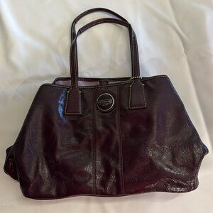 Coach handbag. Color plum. Never used. Perfect condition dust bag included